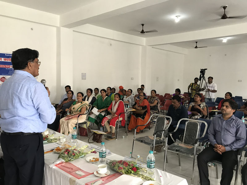 A speaker addressing a seated audience at a SIET training seminar